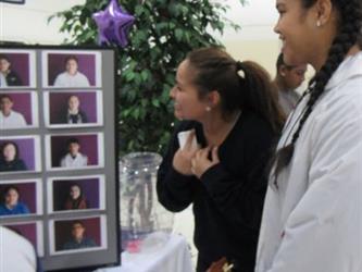 Students view gallery of images of students who received an honor roll award.