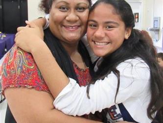 Proud mother poses with her honor roll daughter.