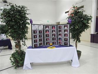 Students view gallery of images of students who received an honor roll award.