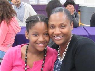 Proud mother poses with her honor roll daughter.