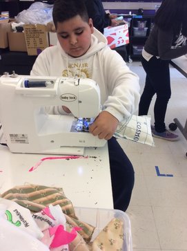 Male student working on a project at a sewing machine.